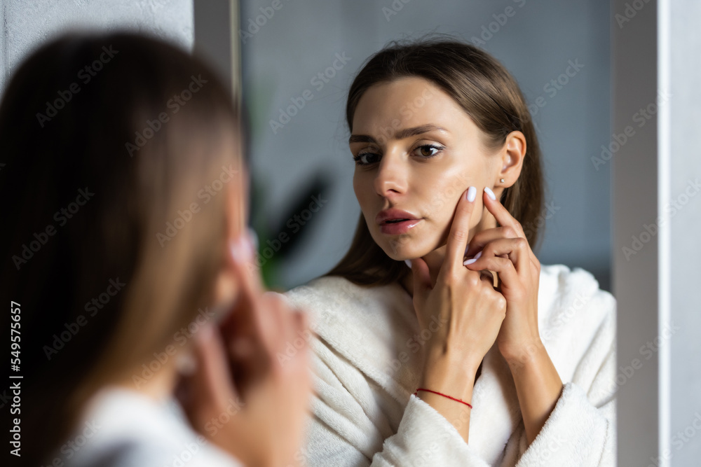 Portrait of woman having problems with skin at home in bethroom Portrait of woman having problems with skin at home in bethroom