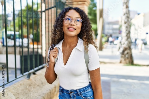 Young hispanic girl smiling happy standing at the city. Free Download Young hispanic girl smiling happy standing at the city. - GFXLoad