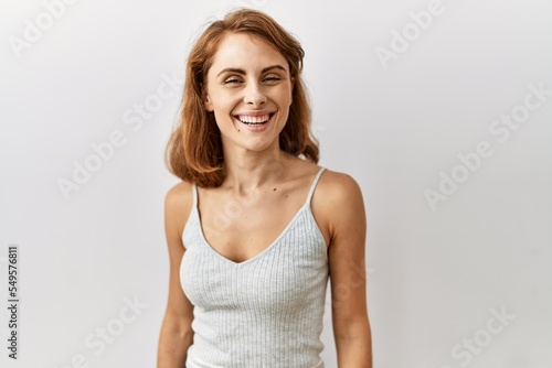 Beautiful caucasian woman standing over isolated background with a happy and cool smile on face. lucky person.