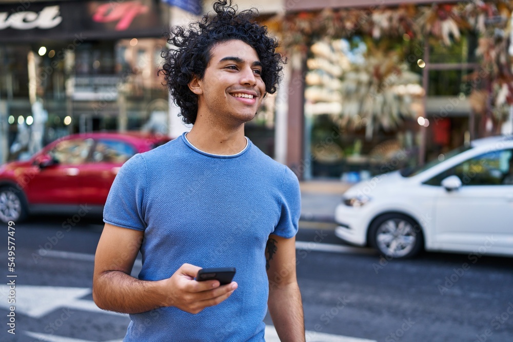Young hispanic man smiling confident using smartphone at street Young hispanic man smiling confident using smartphone at street