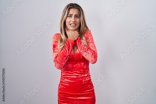Young blonde woman wearing sexy party dress shouting and suffocate because painful strangle. health problem. asphyxiate and suicide concept.