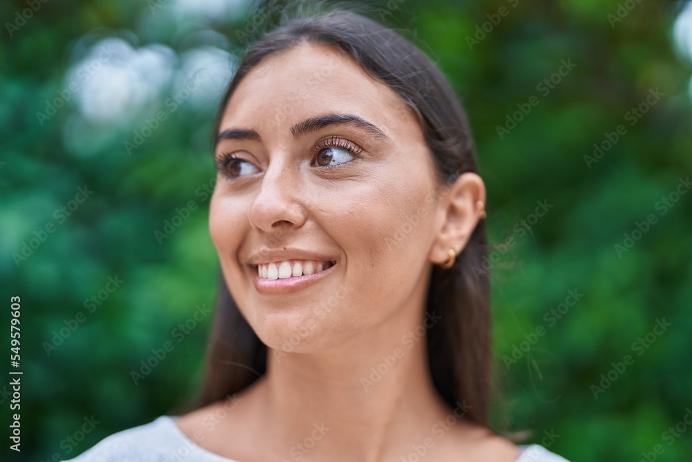 Young beautiful hispanic woman smiling confident looking to the side at park Young beautiful hispanic woman smiling confident looking to the side at park