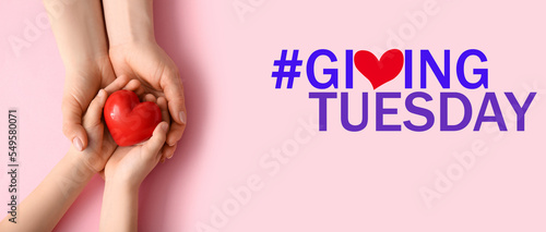 Banner with hands, heart and text GIVING TUESDAY on pink background