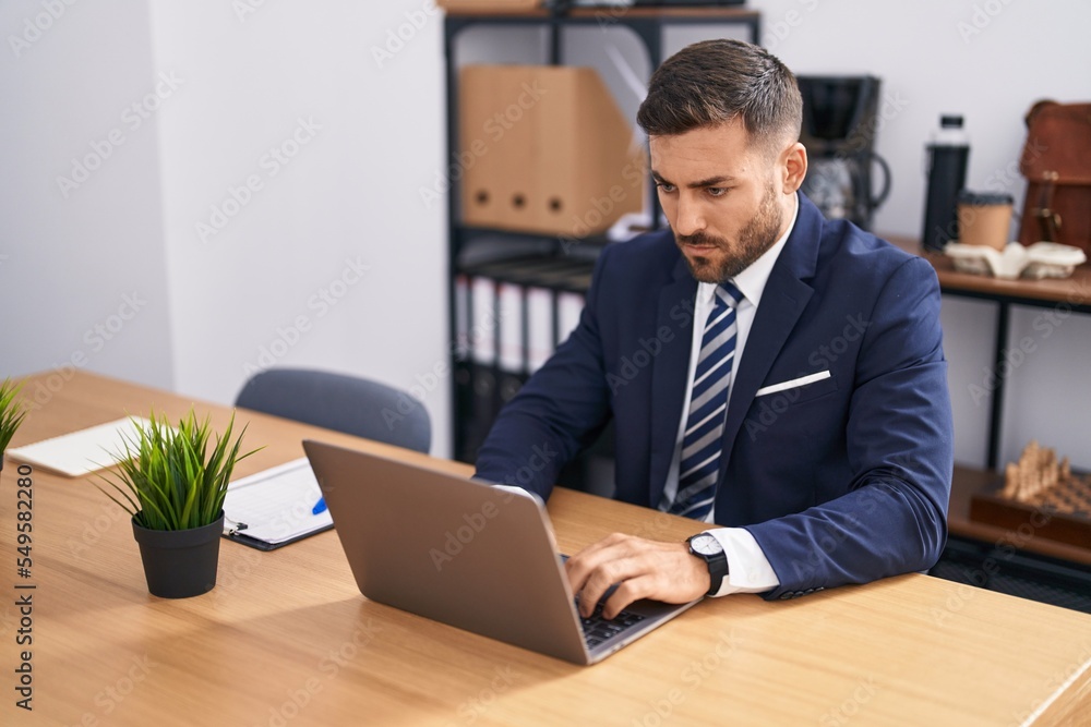 Young hispanic man business worker using laptop working at office Young hispanic man business worker using laptop working at office