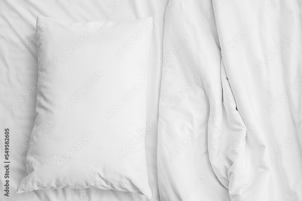 Soft crumpled bedding and pillow, closeup