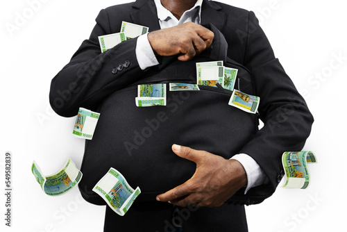 Businessman holding black bag full of Djiboutian franc notes isolated on white background, money falling from bag photo