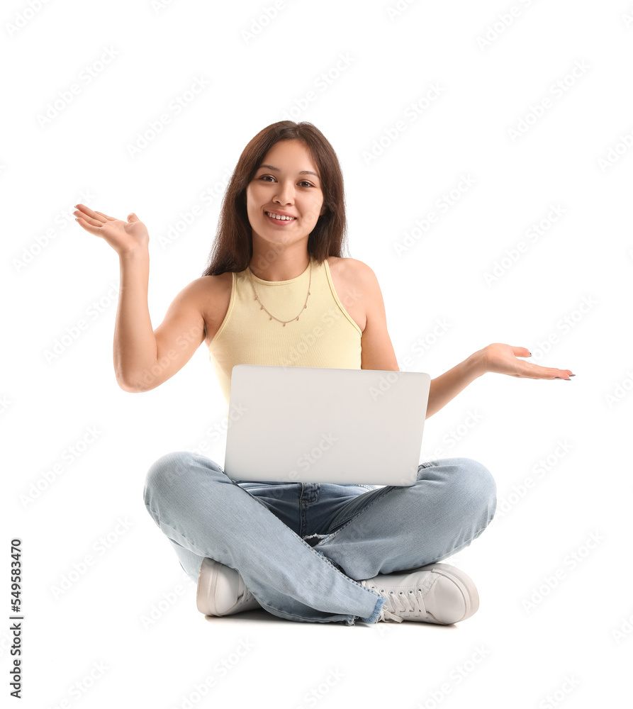 Young Asian woman with laptop sitting on white background Young Asian woman with laptop sitting on white background
