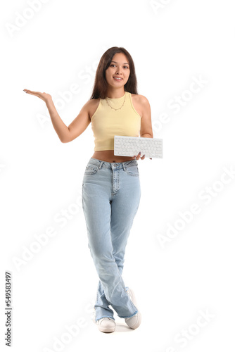 Young Asian woman with computer keyboard showing something on white background