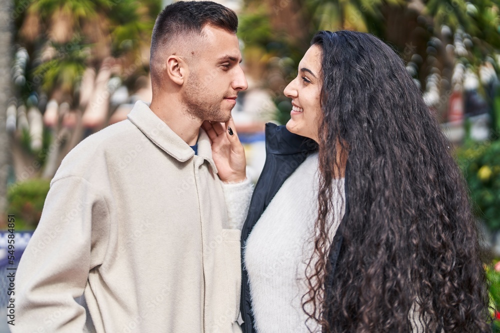 Fototapeta premium Man and woman couple smiling confident standing together at park