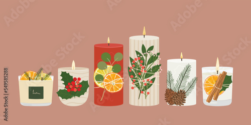 Obraz na plátně Set of Christmas scented soy, paraffin wax candles with dried oranges, cinnamon, winter greenery, berries in glass, container