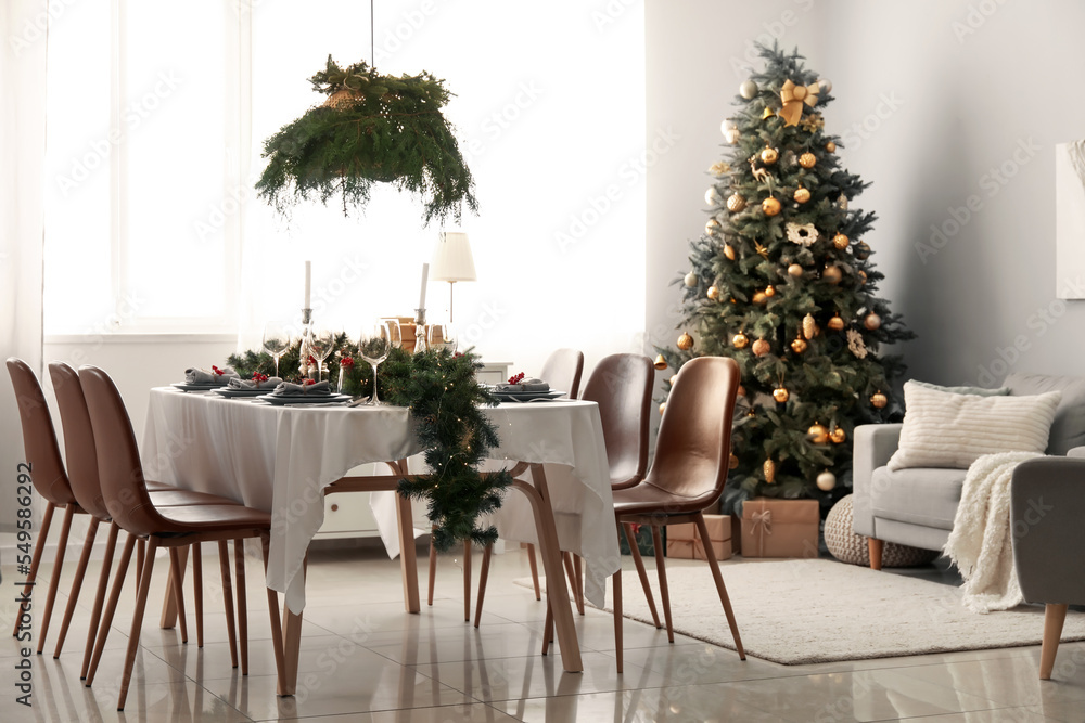 Interior of dining room with table and Christmas tree