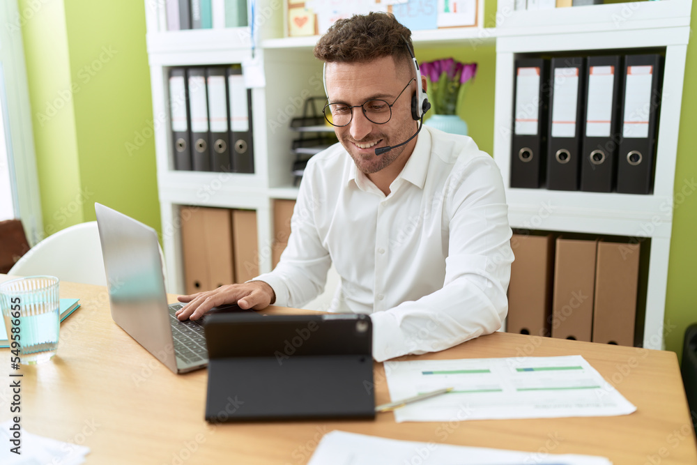 Young hispanic man call center agent working at office Young hispanic man call center agent working at office