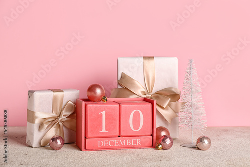Canvas Print Cube calendar with date 10 DECEMBER, Christmas balls and gifts on table near pin