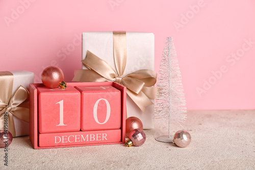 Canvas Print Cube calendar with date 10 DECEMBER, Christmas balls and gifts on table near pin