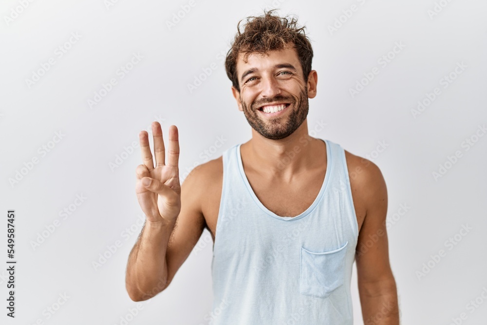 Young handsome man standing over isolated background showing and pointing up with fingers number three while smiling confident and happy. Young handsome man standing over isolated background showing and pointing up with fingers number three while smiling confident and happy.