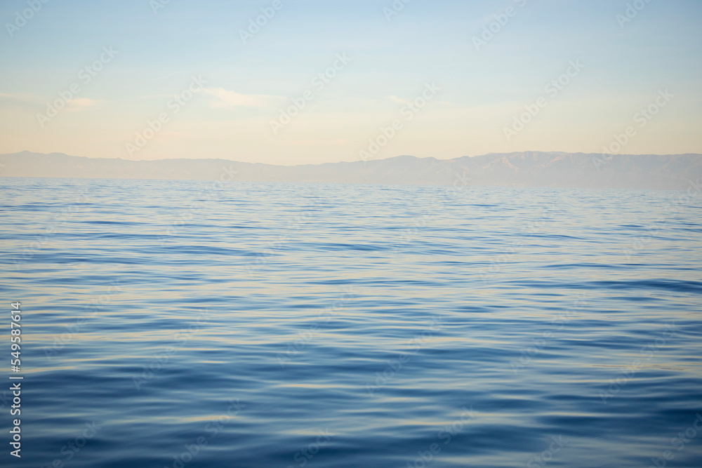 sunset over calm ocean water sunset over calm ocean water