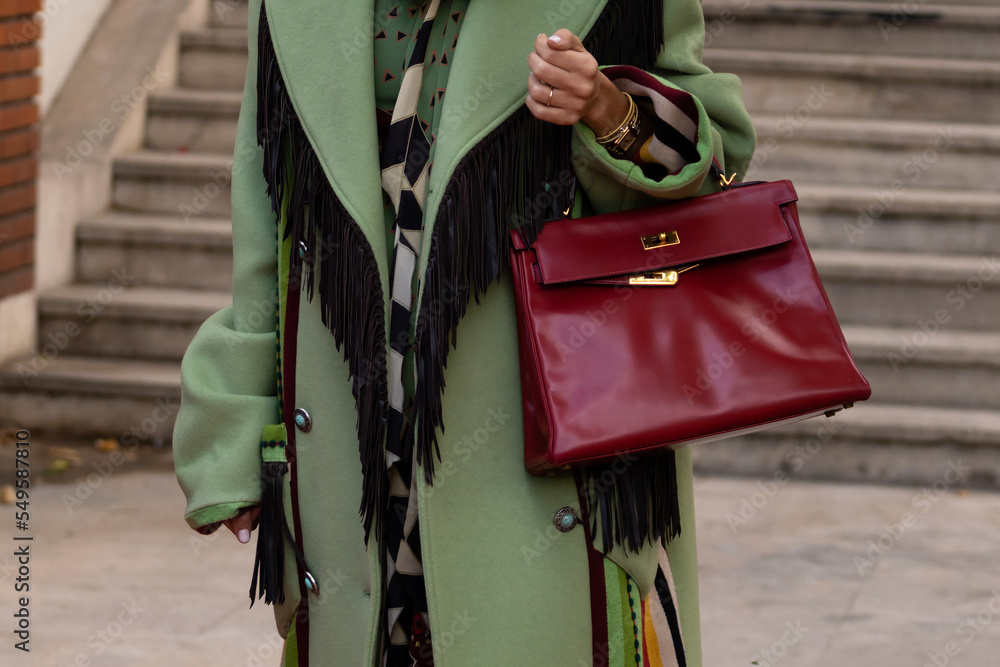 Paris, France - October, 1: woman wearing vintage Kelly 32 bag from Hermes  in burgundy calf box leather, street style outfit details. 素材庫相片