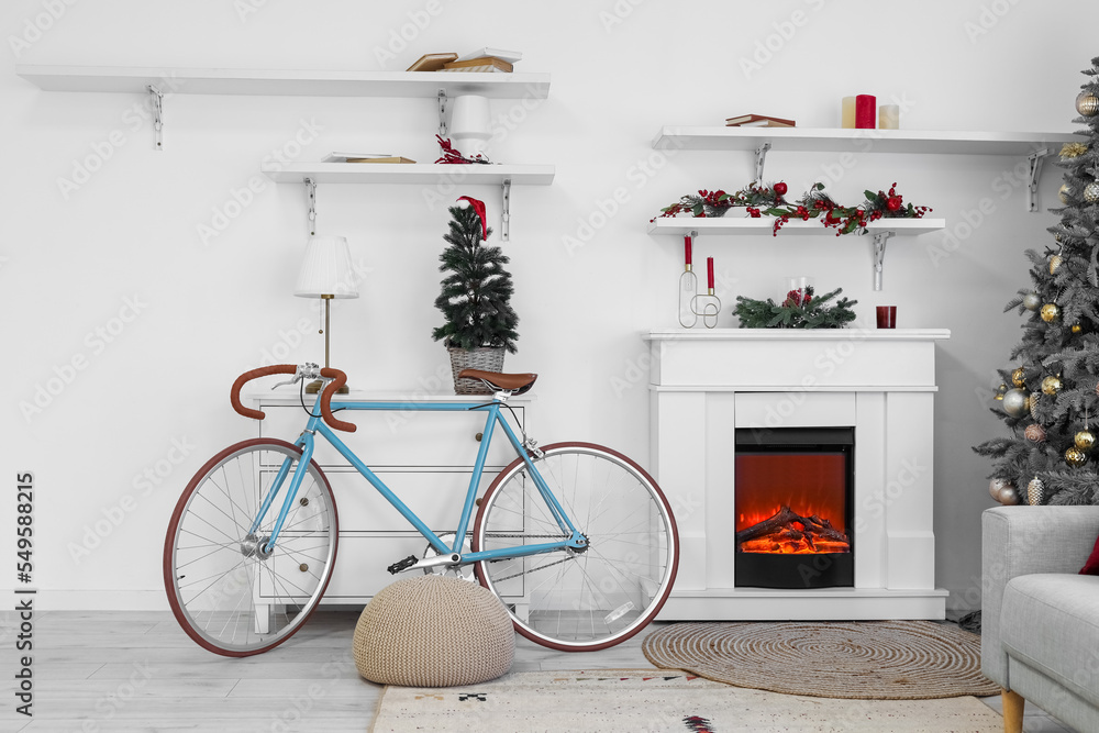 Fototapeta premium Interior of living room with Christmas tree, fireplace and bicycle