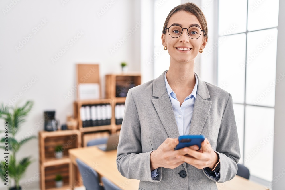 Young caucasian woman business worker smiling confident using smartphone at office Young caucasian woman business worker smiling confident using smartphone at office