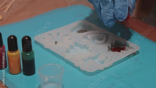 woman making christmas ornaments with epoxy resin