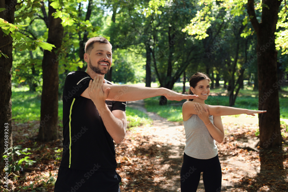 Man and woman doing morning exercise in park Man and woman doing morning exercise in park