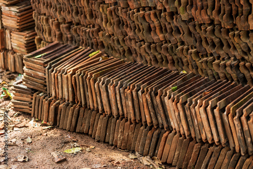 Long receding row of red roof tiles stacked