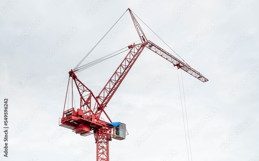 View of the construction site and red cranes for building modern residential area, construction concept for the develop city. View of the construction site and red cranes for building modern residential area, construction concept for the develop city.