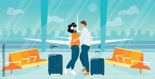 Happy couple with suitcases in hall of airport