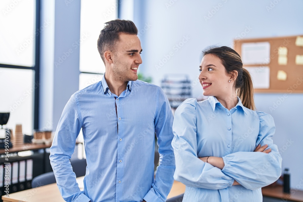 Man and woman business workers smiling confident standing with arms crossed gesture at office Man and woman business workers smiling confident standing with arms crossed gesture at office