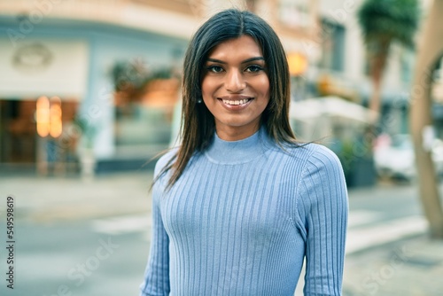 Beautiful hispanic woman smiling confient at the city