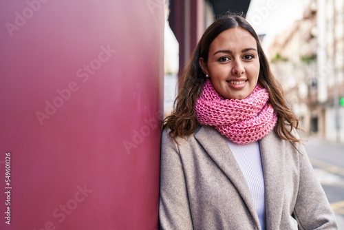 Young beautiful hispanic woman smiling confident wearing scarf at street