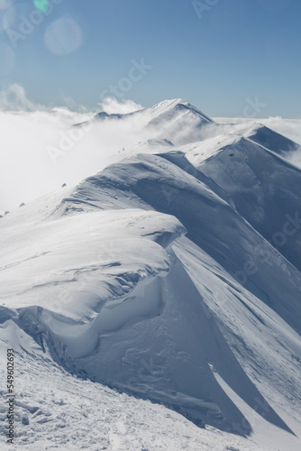 Hanging snow cornices on the mountain ridge © almostfuture