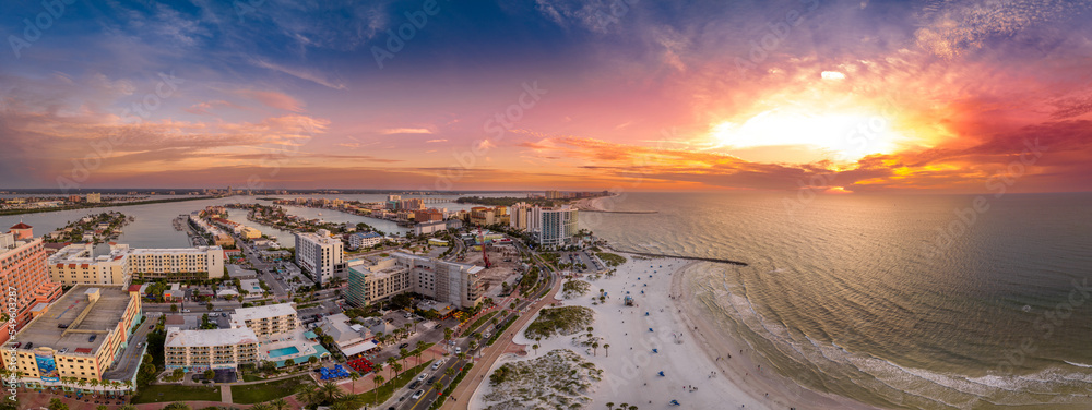 Aerial sunset view of Clearwater beach and Sand key in Western Florida on the Mexican Gulf coast with vacation homes, hotels and bridges connecting