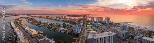 Aerial sunset view of Clearwater beach and Sand key in Western Florida on the Mexican Gulf coast with vacation homes, hotels and bridges connecting photo