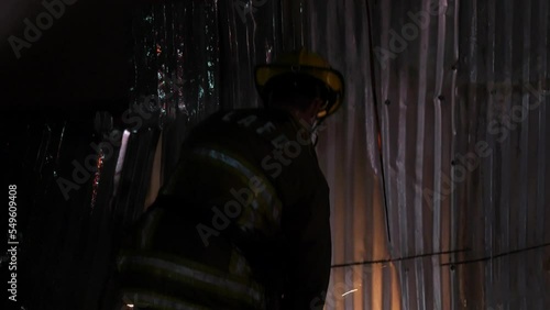 firefighter cutting metal building hd photo