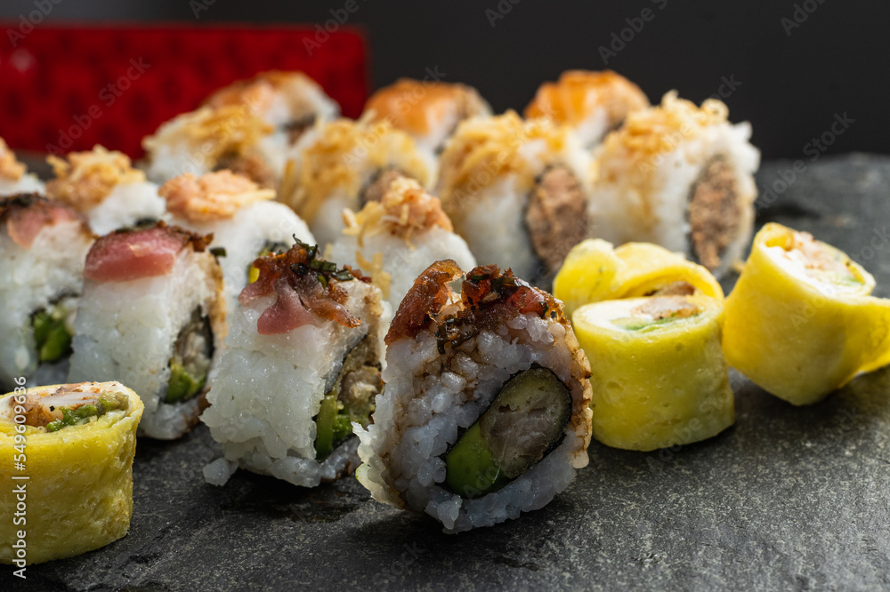 delivery of sushi roll at home with Chinese sticks and ginger