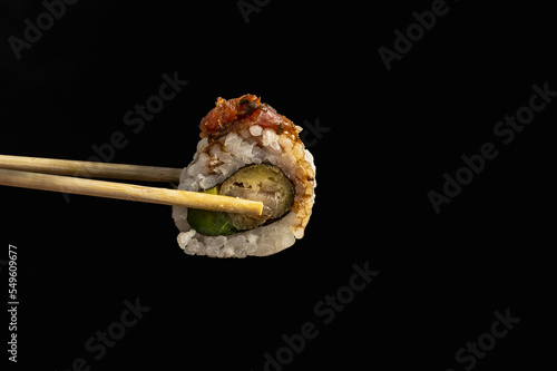 delivery of sushi roll at home with Chinese sticks and ginger