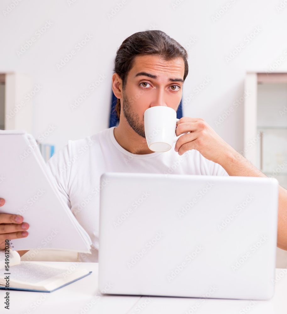 Young male student preparing for exams at home Young male student preparing for exams at home