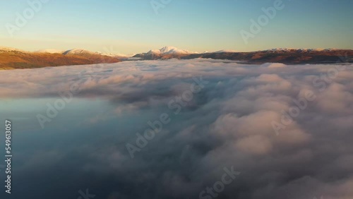 Beautiful sunrise over Loch Lomond flying above the clouds with Ben Lomond in the distance photo