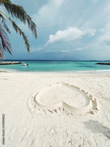 The heart of white sand on the luxurious beach of the Maldives. Place for text. The concept of holidays in the Maldives, tourism, travel and vacation. © Alisa