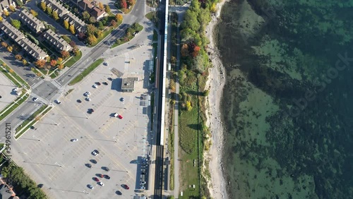 Picking  Train Station Rouge station drone view with houses and Lake Ontario in view   and go train on train tracks  photo