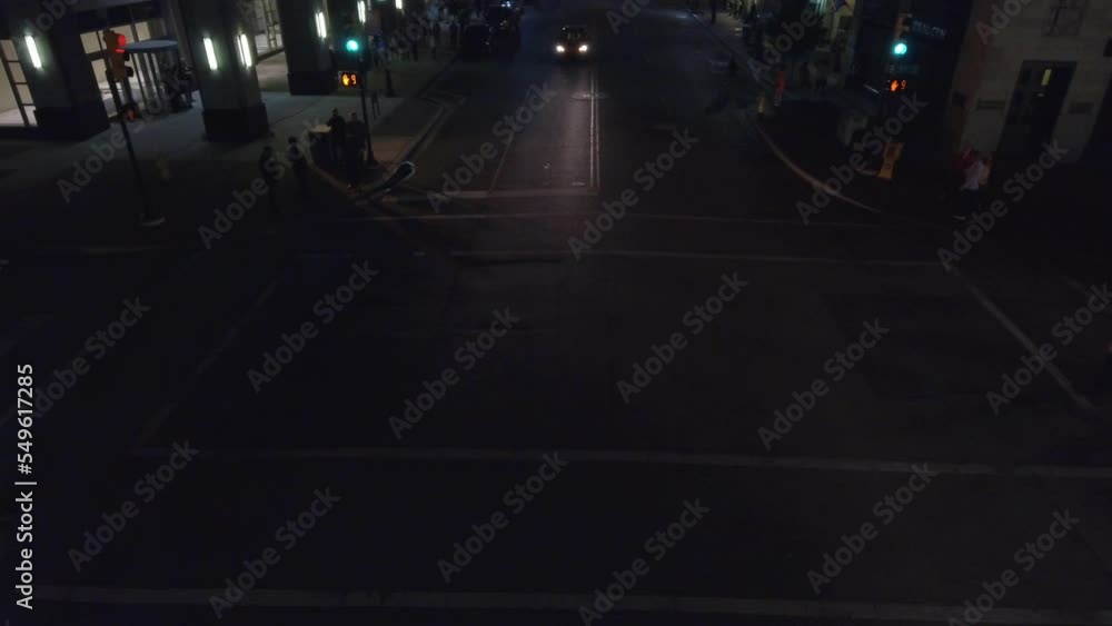 Aerial drone shot of car standing in the red signal in the city with people crossing the road at night . Car stands on a red and yellow traffic light
Aerial drone shot of car standing in the red signal in the city with people crossing the road at night . Car stands on a red and yellow traffic light