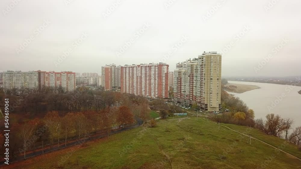 aerial view of a field and a wasteland on the outskirts of a city with high-rise buildings of modern architecture near a wide river on an autumn cloudy and rainy day aerial view of a field and a wasteland on the outskirts of a city with high-rise buildings of modern architecture near a wide river on an autumn cloudy and rainy day