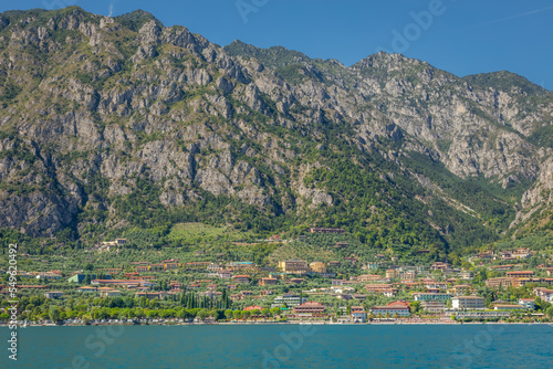 Idyllic Lake Garda and Limone sul Garda old town with boat, Italian alps © Aide