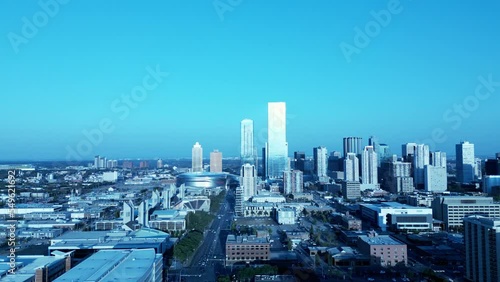 Edmonton West to East over 104 Ave NW aerial over MacEwan University Allard Hall up to NHL Rogers Arena stunning sparkling reflection of the downtown skyline sunny summer day lush green trees YEG photo