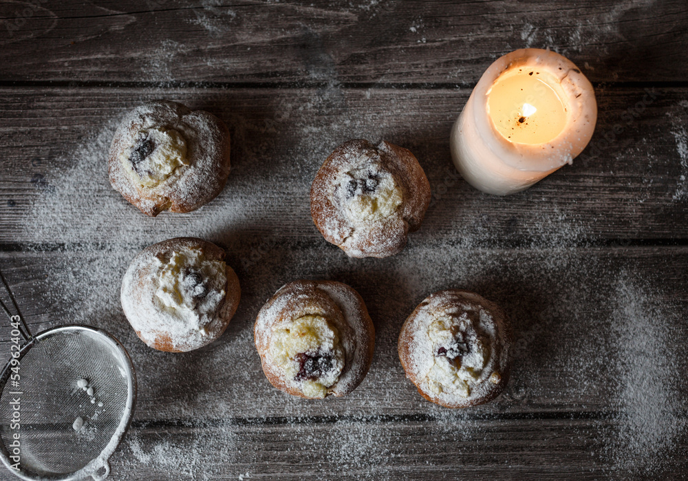 muffins with custard, berries and powdered sugar on a wooden table muffins with custard, berries and powdered sugar on a wooden table