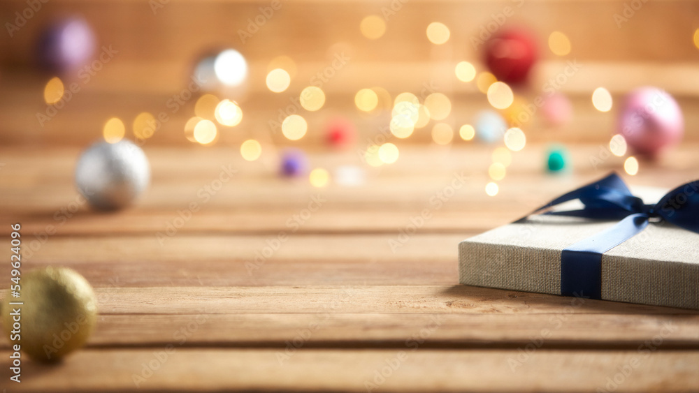 Naklejka premium christmas gifts with natural wood background and lights