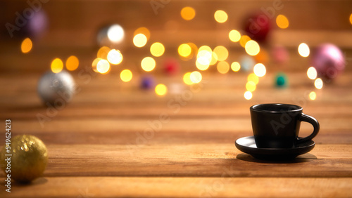 christmas lights and coffee cup on wooden background