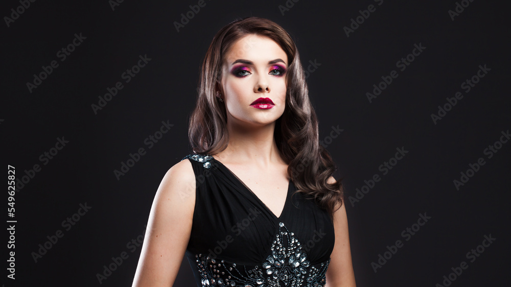 Gorgeous young brunette in a chic evening look. Scarlet lips and eye shadow, wave hair styling Gorgeous young brunette in a chic evening look. Scarlet lips and eye shadow, wave hair styling