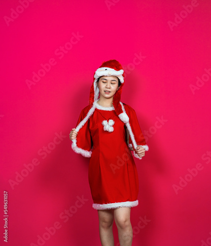 Young Asian Woman Posing While Wearing Her Christmas Themed Attire With Isolated Red Background